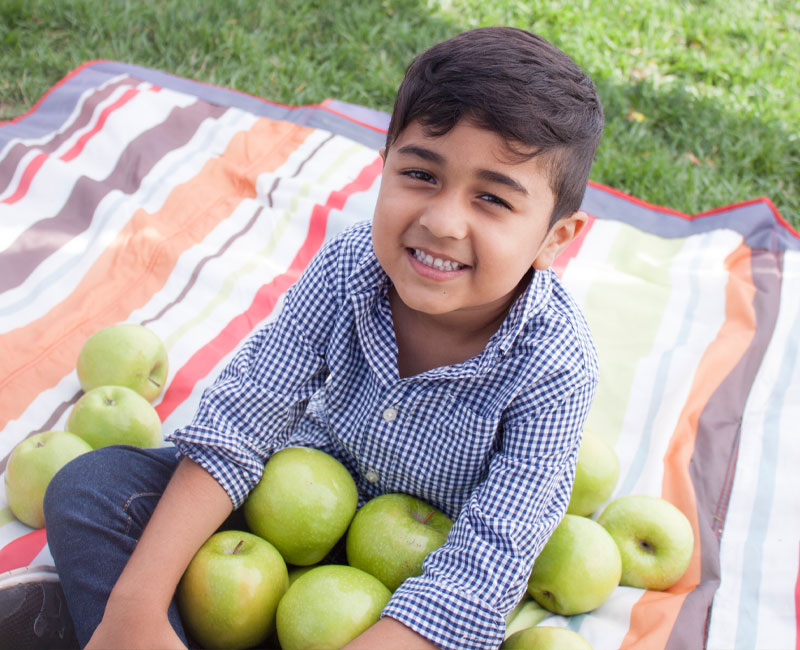 boy with apples teeth cleaning from AIMS Dentistry at Sheppard North York, ON